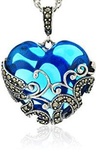 Marcasites wrap around blue heart.