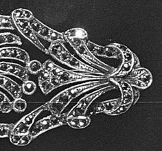 Marcasites in silver brooch are small and dainty but the image is enlarged to show detail on the left side of the pin.