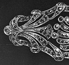 Marcasites in silver brooch are small and dainty but the image is enlarged to show detail on the right side of the pin.
